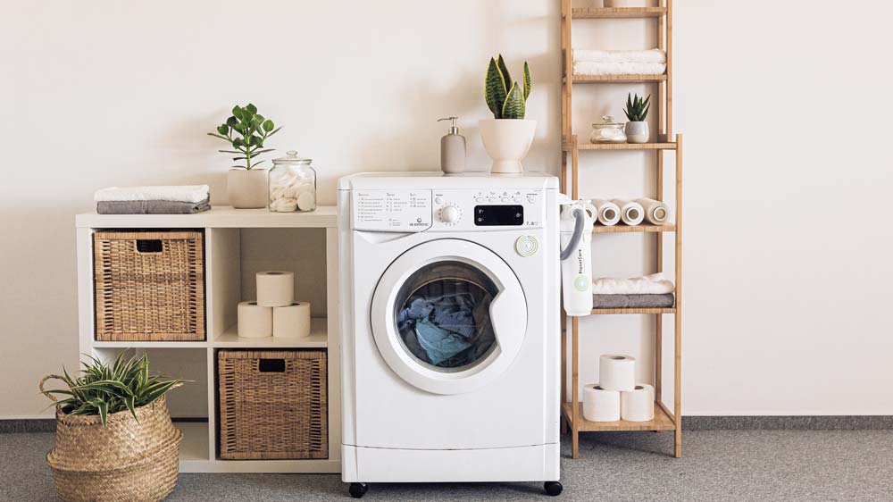A white washing machine with a load of laundry in it